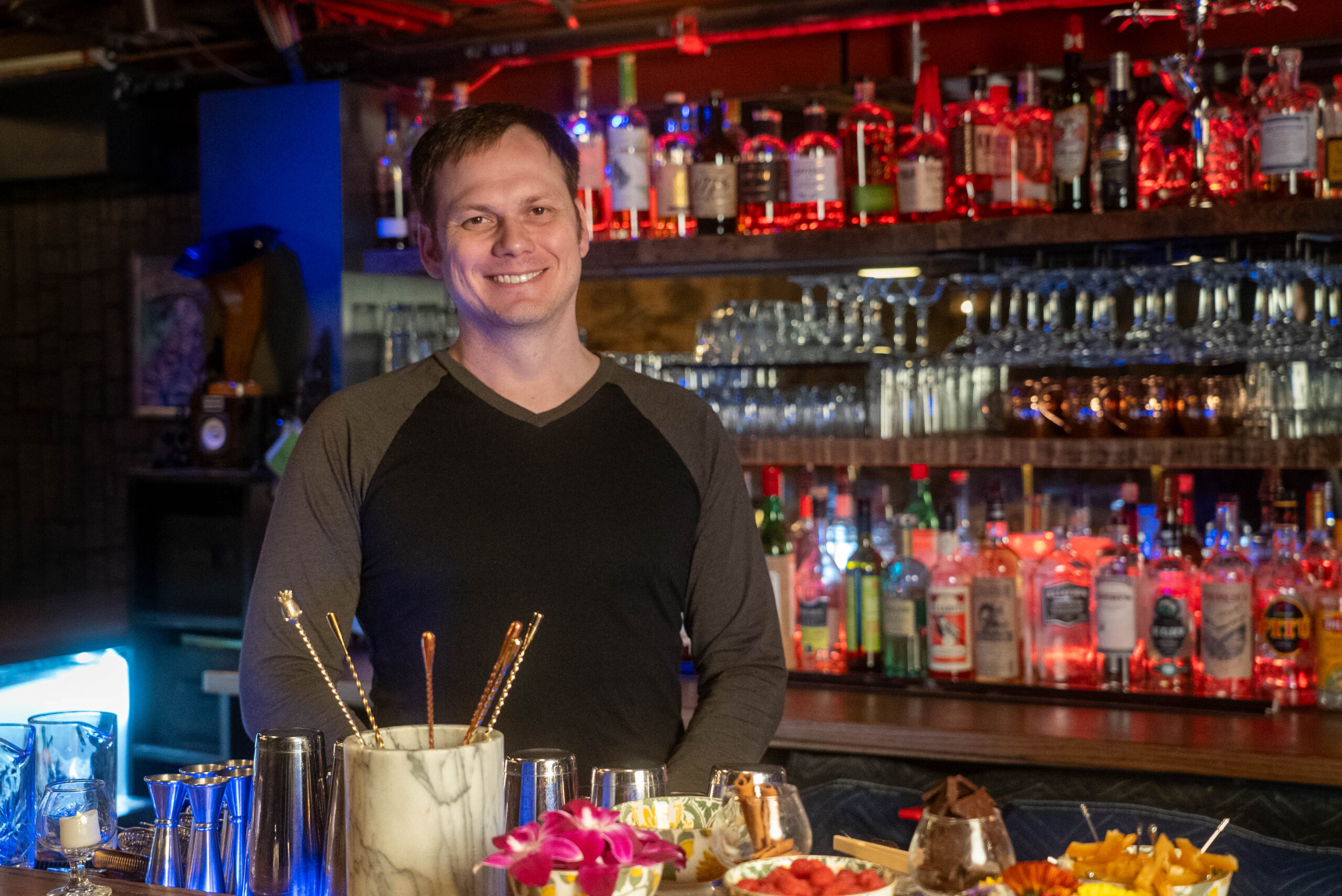 Owner standing behind the bar.