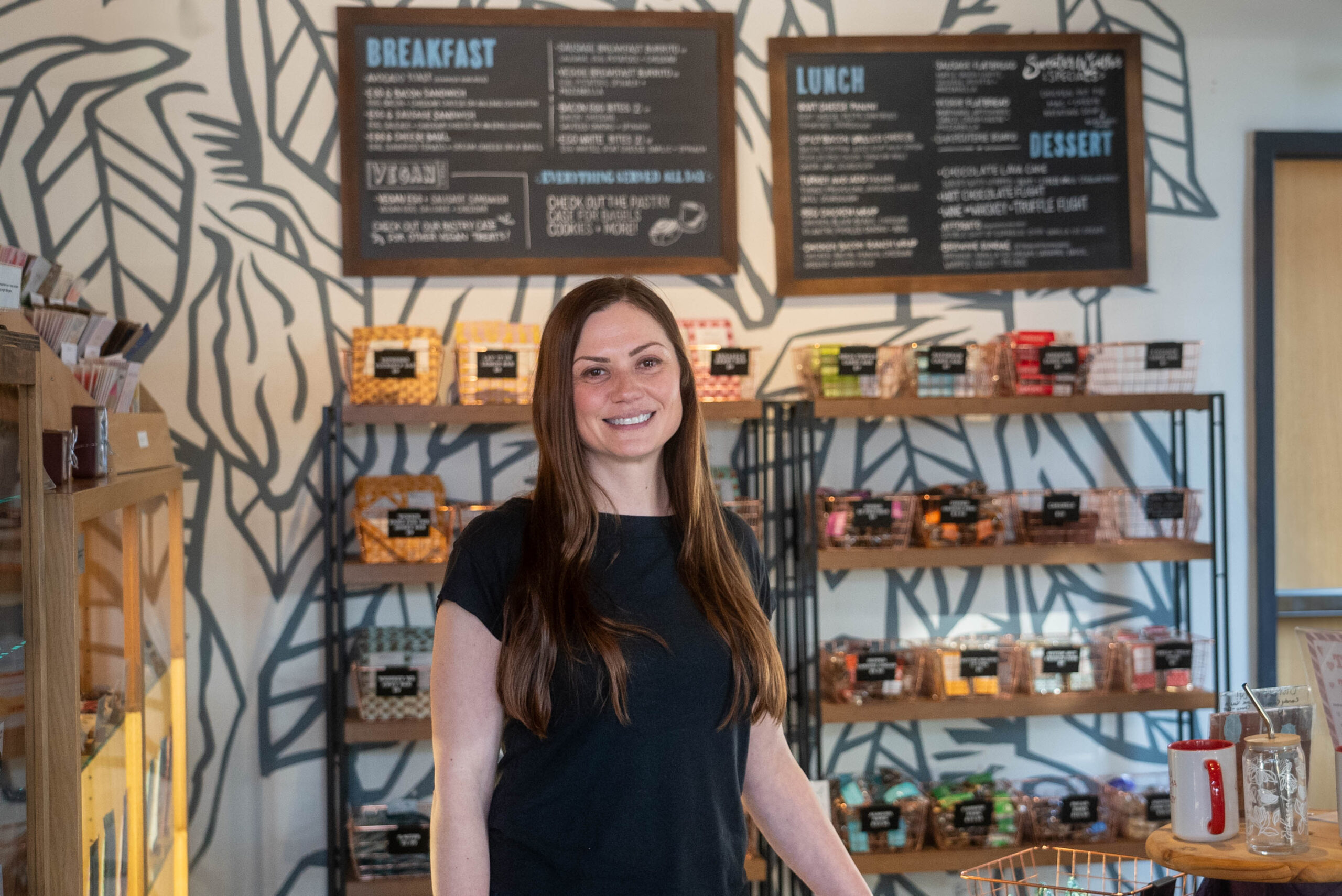 Owner standing in front of their products.