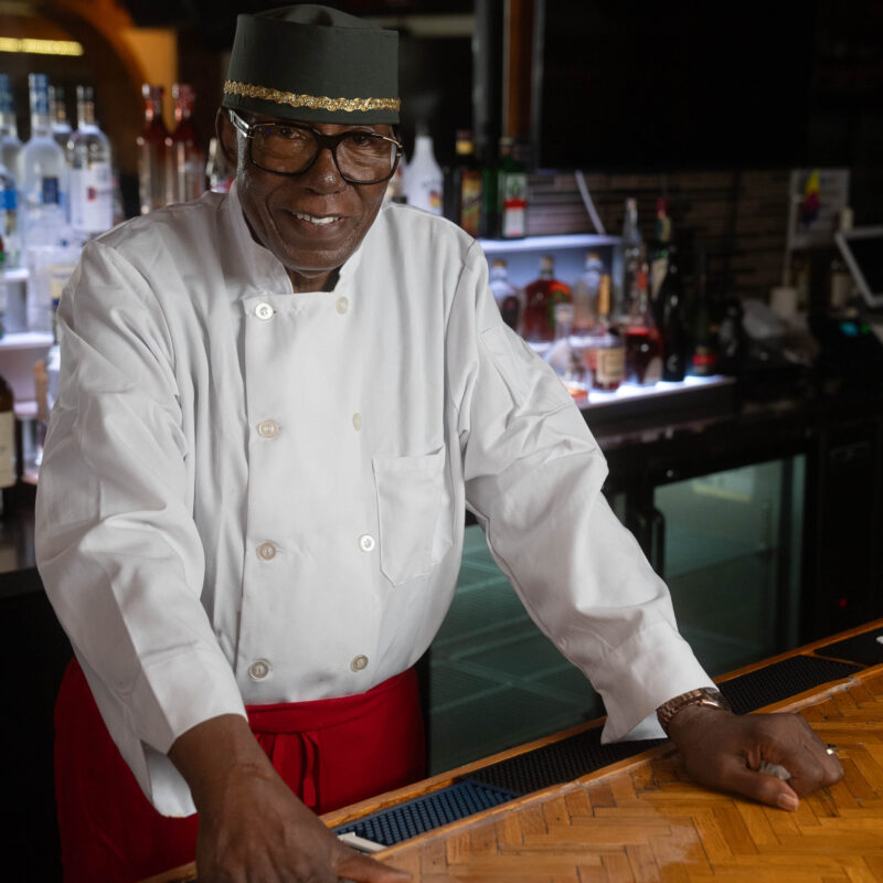 Charlie Robinson standing behind the bar.